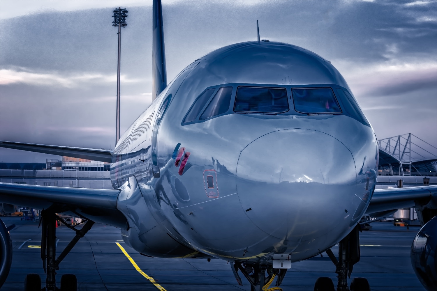 aircraft taxiing at an airport at dusk